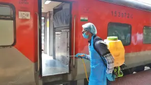 Train coaches being sanitized by the worker.
