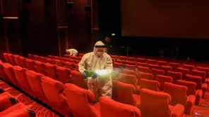 Employees sanitizing the cinema hall